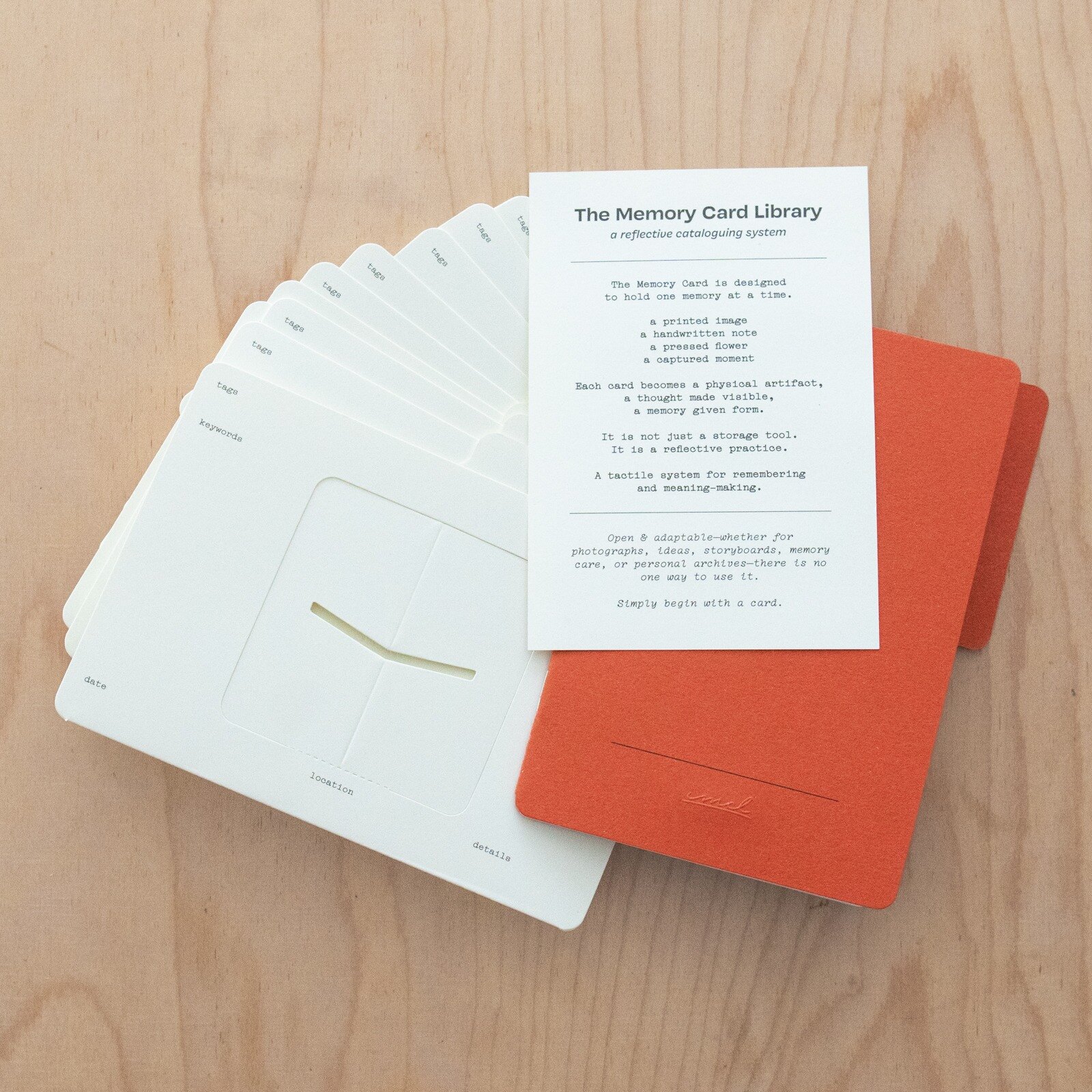 A Memory Card Library set with blank Memory Cards, an orange notebook and a printed guide