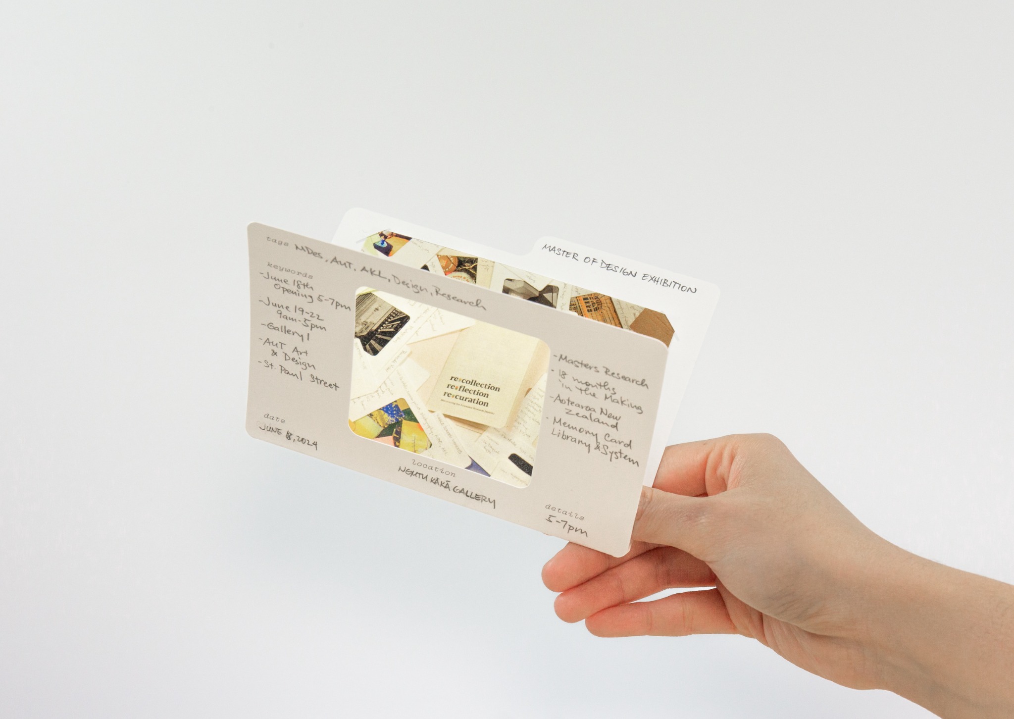 A hand holding two layered Memory Cards with photographs and handwritten reflections